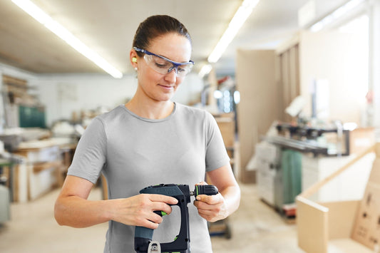 Festool CXS 18-Basic Akku-Bohrschrauber mit ergonomischer C-Form in Anwendung bei der Arbeit in einer Werkstatt.